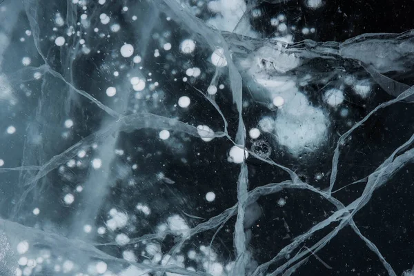 Buz dokusu yakın plan. Sibirya 'daki donmuş Baykal Gölü. Hava ve metan baloncukları ile güzel kırılmış buz. 