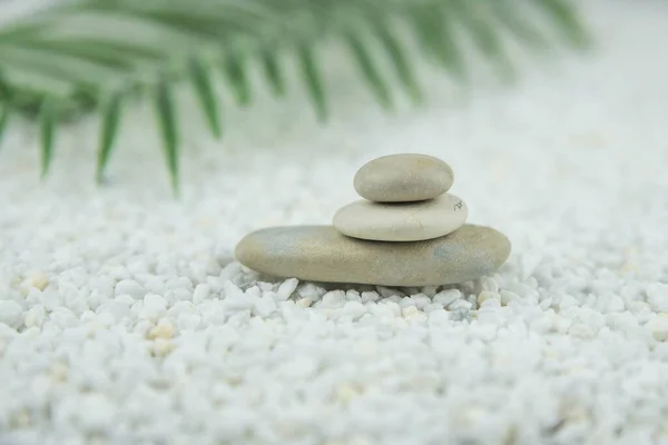 Pyramids of gray and white zen pebble meditation stones on white background. Concept of harmony, balance and meditation, spa, massage, relax