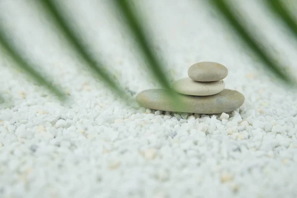 Pyramids of gray and white zen pebble meditation stones on white background. Concept of harmony, balance and meditation, spa, massage, relax