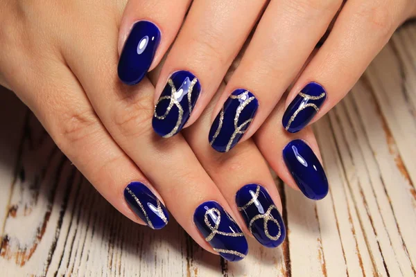 beautiful blue manicure on a beautiful textural background