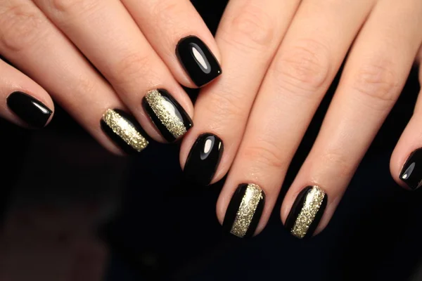 Fashionable black manicure on beautiful female hands