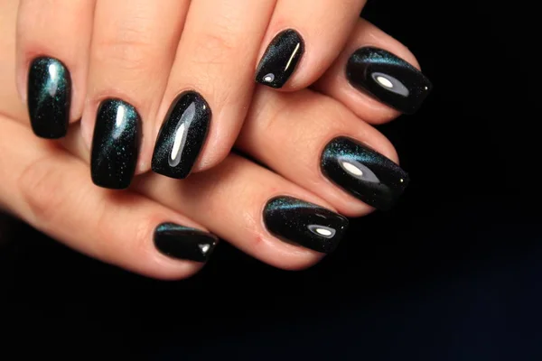 glam black manicure on beautiful female hands