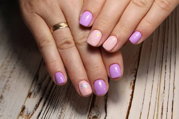 pink manicure with a design on a stylish background