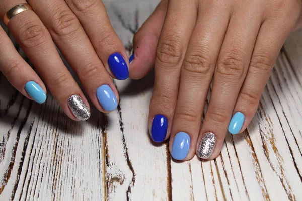 fashionable blue manicure with a design on beautiful nails