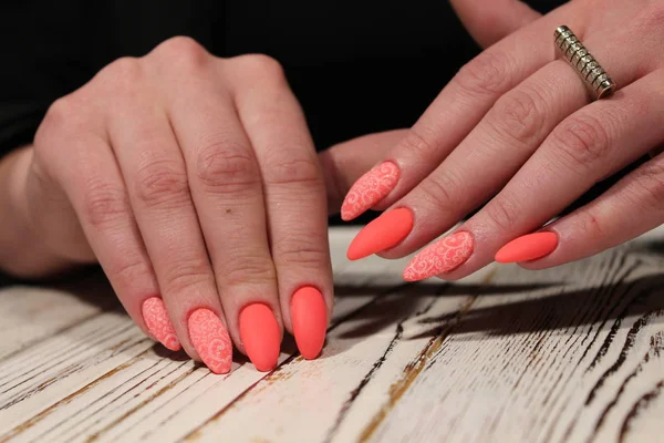 beautiful orange manicure with a design pattern