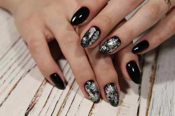 fashionable black manicure on long beautiful nails