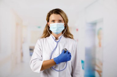 Steteskoplu koruyucu giysili kadın doktor.