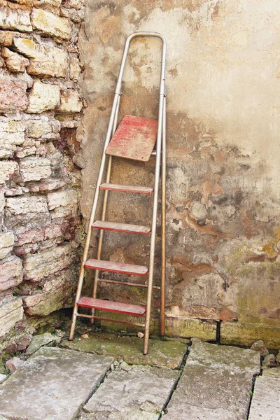 stepladder leaning against the wall