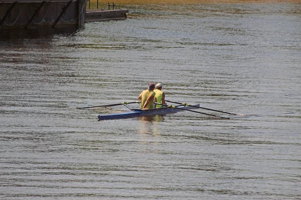 two male athletes in a kayak on the river