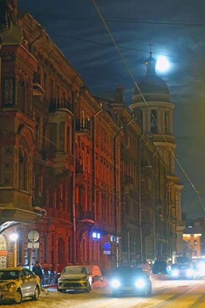 full moon over winter city street