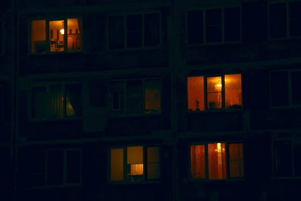 lighted night windows of houses