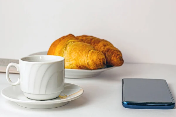 Morning Breakfast Cup Coffee Croissants Newspaper Mobile Phone Table — Stock Photo, Image