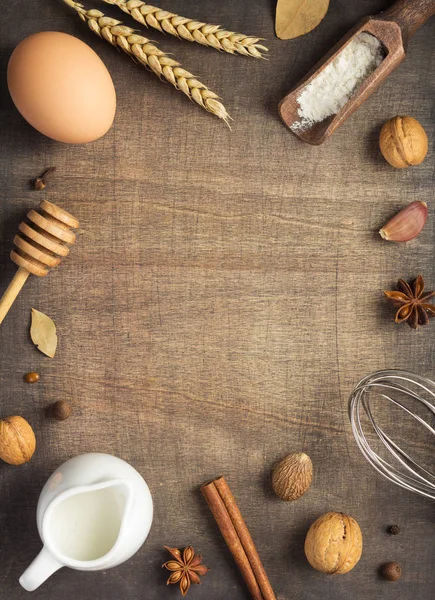 bakery and bread ingredients on wooden background, top view