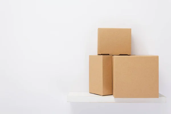 Cardboard box on wooden shelf — Stock Photo, Image