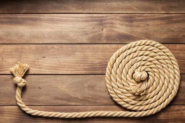 Ship rope at wooden background texture — Stock Photo, Image