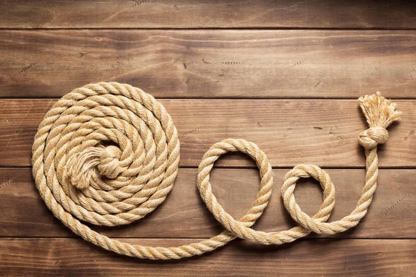 Ship rope at wooden background texture — Stock Photo, Image