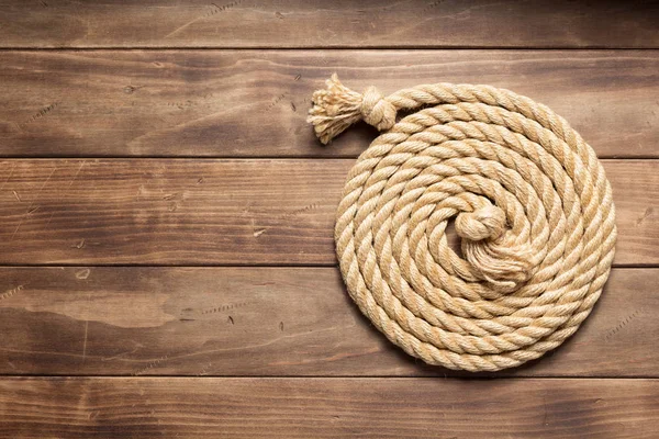 Ship rope at wooden background texture — Stock Photo, Image