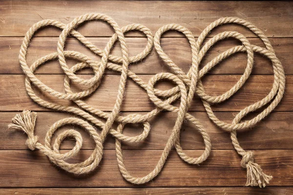 Ship rope at wooden background texture — Stock Photo, Image