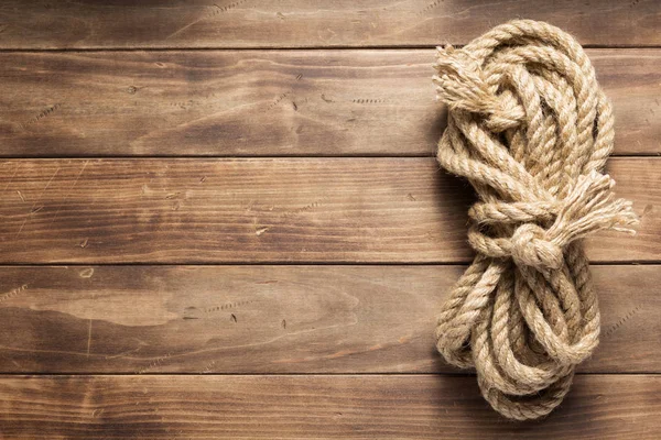 Ship rope at wooden background texture — Stock Photo, Image