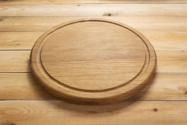 Pizza cutting board at rustic wooden table — Stock Photo, Image