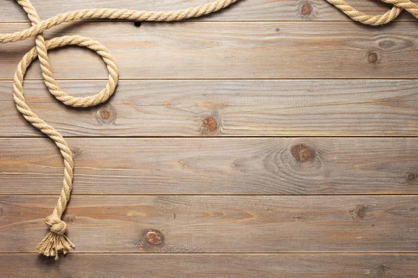 Ship rope at wooden background texture — Stock Photo, Image