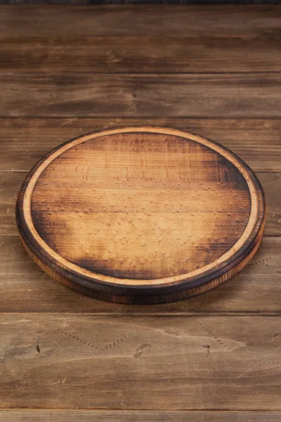 Pizza cutting board at rustic wooden table — Stock Photo, Image