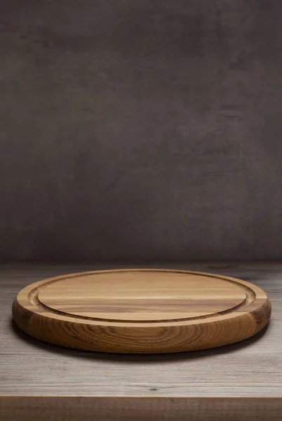 Pizza cutting board at rustic wooden table — Stock Photo, Image