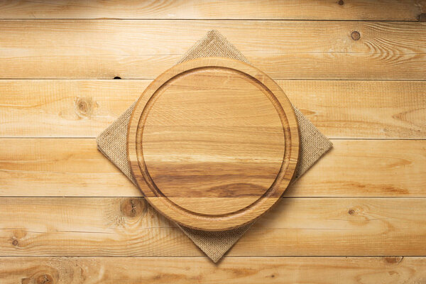 pizza cutting board and napkin at rustic wooden table