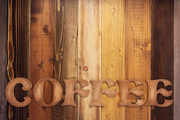 coffee letters aged wooden board background as texture surface