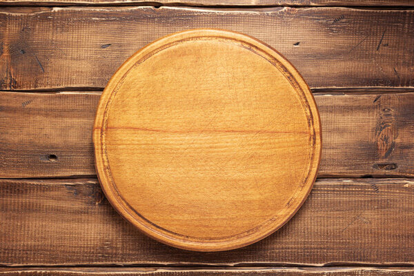 pizza cutting board or tray at wooden background texture