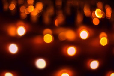 Black abstract background with blurred red, yellow and white circles