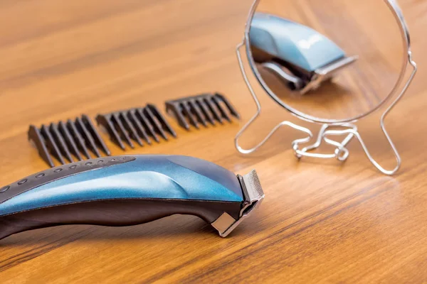 Trimmer for haircut on the table in the hairdressing salon. Mirror and tool a hair clipper in the beauty salon