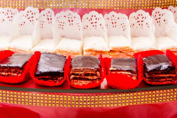 Sweet cakes set out in a row on a festive table