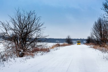 Kış yolun karla kaplı. Otobüsü kış yol boyunca hareket eder.
