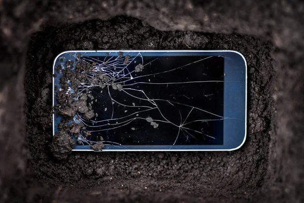 Burial of a broken cell phone. The phone can not be repaired