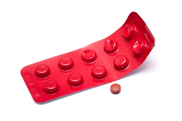 白色孤立背景下的褐色药丸和红色水泡 — 图库照片