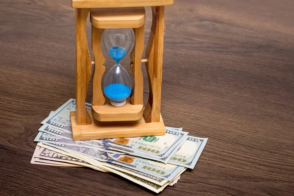 Sand Clock on dollar bills. Economy of time, time - money