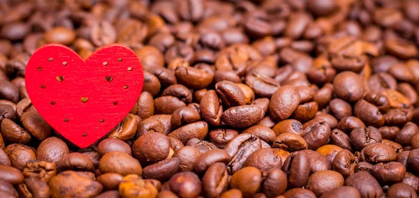 Red heart among coffee beans. I love coffee. Copy space