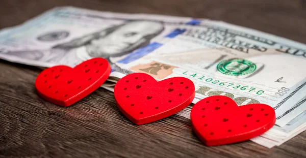 Red hearts on US dollars. Love money