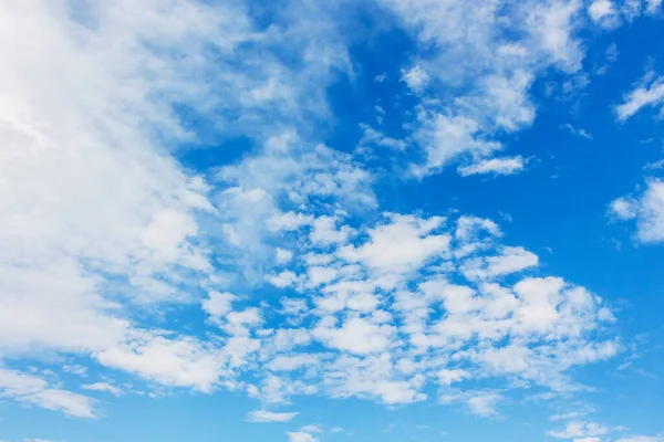White clouds on blue sky in sunny weather
