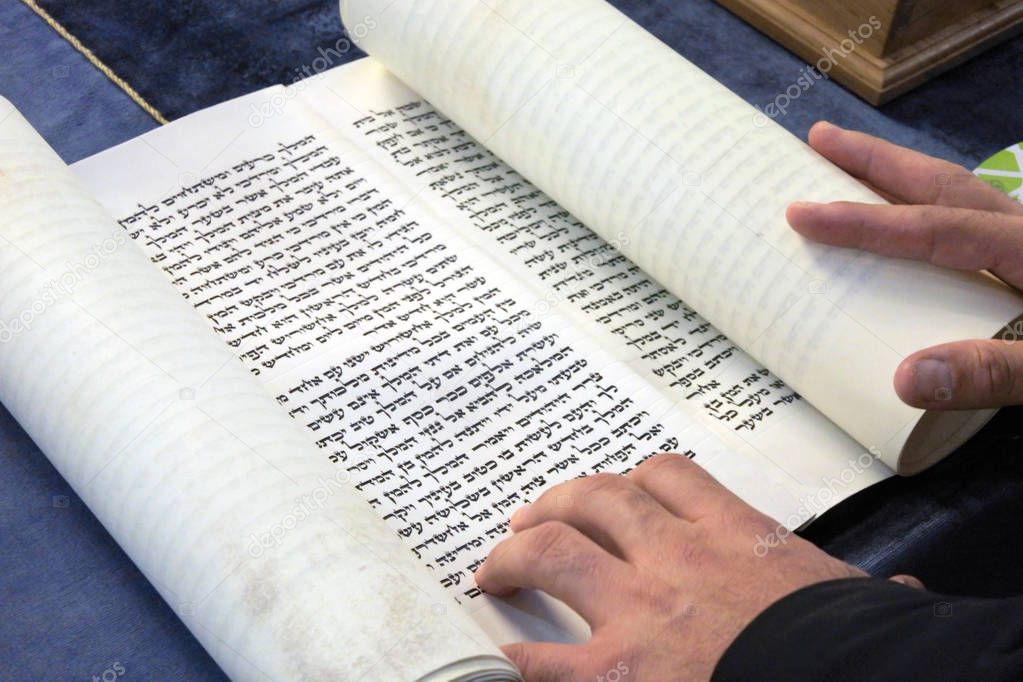 Jewish Rabbi reads The Megillah Scroll (Book of Esther) on Purim Jewish holiday.