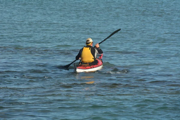 Man kayaking with a sea kayak