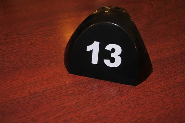 Number 13 table number on a wooden table — Stock Photo, Image