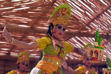 Balinese women dancing Tari Pendet Dance in Bali Indonesia clipart