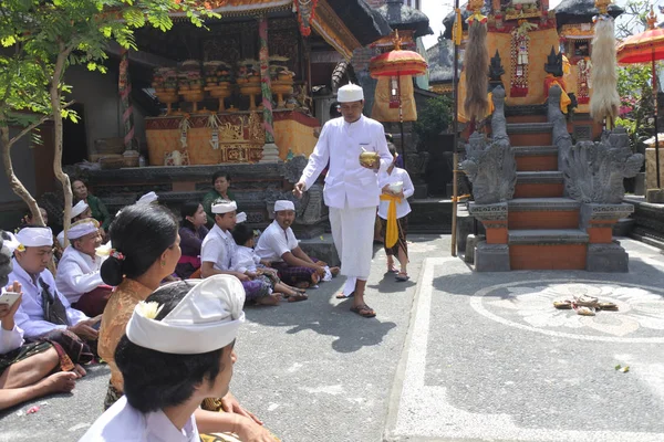 Sacerdote indù che benedice la famiglia balinese festeggiando Galungan Kunin — Foto Stock