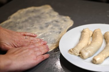 Jewish woman preparing Jachnun or Jahnun, a Yemenite Jewish pastry, originating from the Adeni Jews, and traditionally served on Shabbat morning. clipart