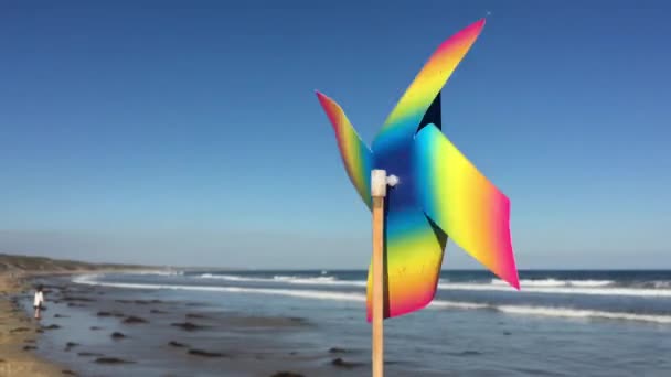 Mainan Angin Pantai Dengan Seorang Gadis Muda Berjalan Latar Belakang — Stok Video
