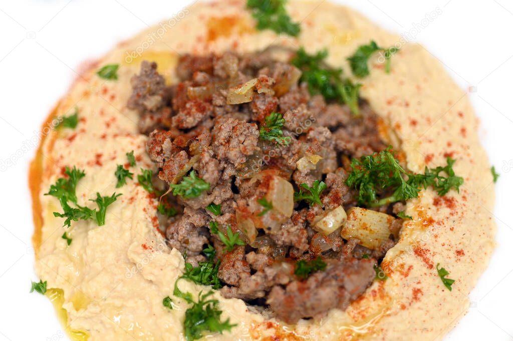 Warm hummus served with ground beef meat, parsley, olive oil and paprika.