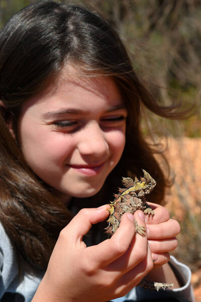 Young Australian girl (age 10) holding a Thorny Devil in Western Australia Outback