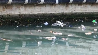 Çöp ve çöp suyun yüzeyinde yüzüyordu. Deniz yüzeyinde kirli ve plastik atık yüzen su kirliliği 